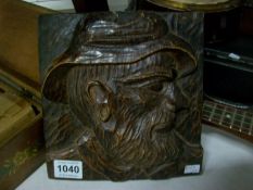 A carved wood plaque