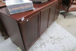 A mahogany effect 4 door sideboard