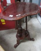 A carved mahogany occasional table