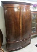 A Victorian mahogany bow front wardrobe