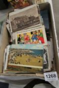 A box of loose postcards including humourous