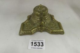 A brass inkwell