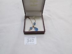 A blue topaz pendant on 9ct gold chain (chain a/f)