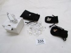 A Swarovski crystal swan, bag of Swarovski hearts, swan pin and other pin