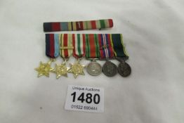 A set of 6 WW2 miniature medals with ribbons and bar