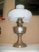 An Aladdin oil lamp with white shade