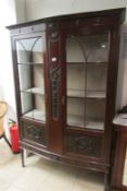 An Edwardian mahogany bow fronted display cabinet