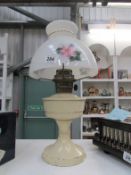 An Aladdin oil lamp with floral shade