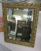 A gilt framed bevel edged dressing table mirror