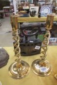 A pair of brass barley twist candlesticks