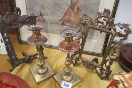 A pair of Victorian metal photo frames and a pair of Arts & Crafts brass candlesticks