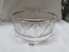 A large glass bowl with silver rim