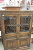 An oak Priory style leaded glass bookcase