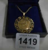 An 1894 Sovereign set in gold Zodiac mount with 9ct gold chain
