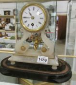 A 19th century French alabaster clock with cherub pendulum