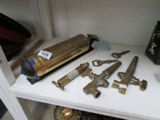 A brass fire extinguisher and quantity of taps