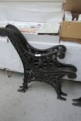 A pair of black cast metal bench ends