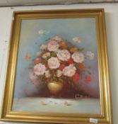 A gilt framed oil on canvas, roses