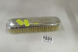 A silver backed clothes brush