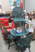 A green cast metal garden table and 4 chairs