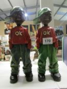 2 black boy figures with 'OK' tops