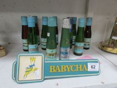 9 bottles of Babycham, 2 Babycham candles and a Babycham sign