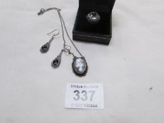 A silver ring set clear stone, silver cameo pendant & pair of silver earrings set jet