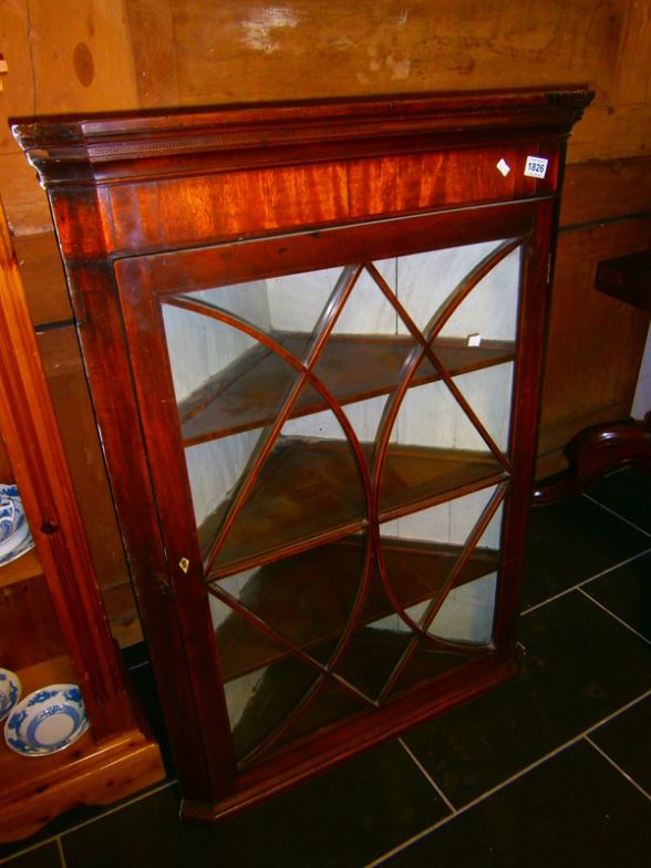 A mahogany astragal glazed corner cupboard