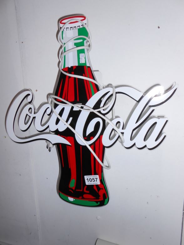 An illuminating Coca Cola sign