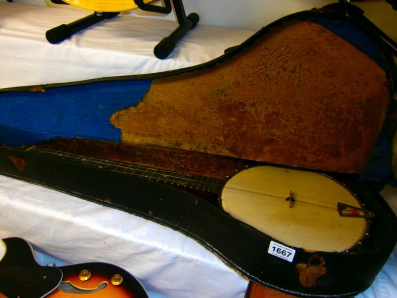 A 5 string banjo in distressed case