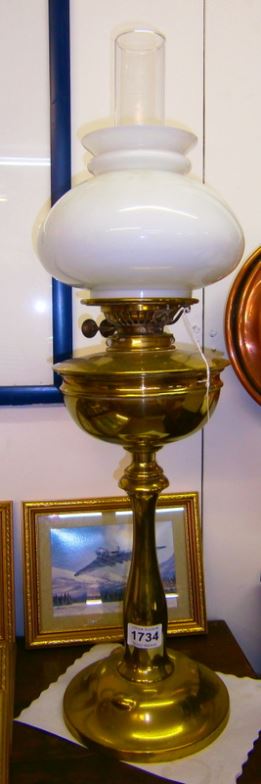 A brass oil lamp with shade