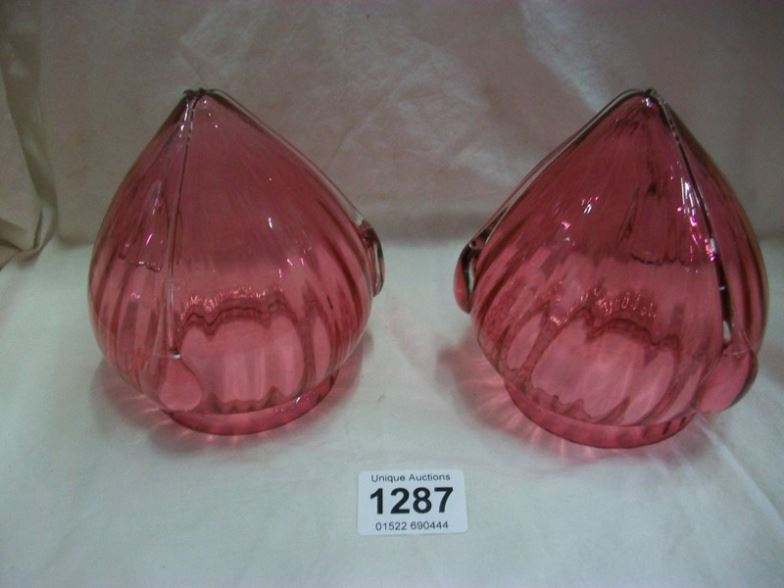 A pair of cranberry glass lampshades