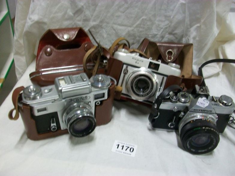 An Olympus OH-IN camera, A Kweb Kiev 4 camera and a Regula 111-A 1956 camera