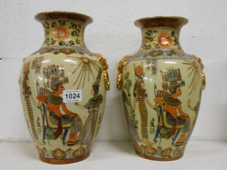 A large pair of vases decorated with Egyptian scenes