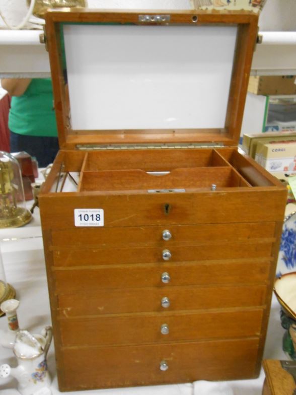 A 5 drawer medical chest with lift up top and contents