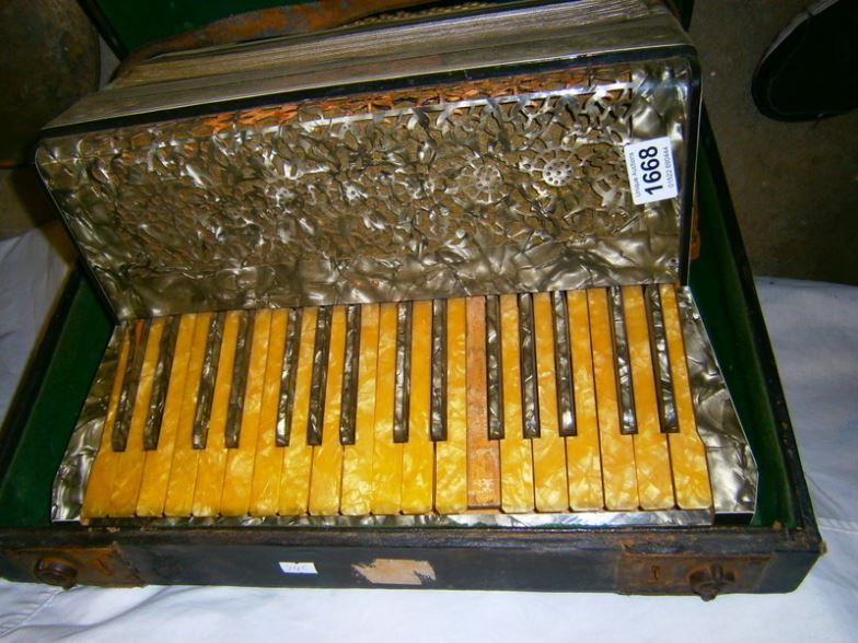 A cased piano accordian