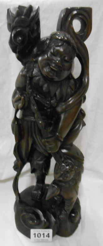 A carved Oriental wooden figure