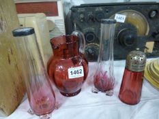 A pair of silver rimmed cranberry glass vases, jug and castor