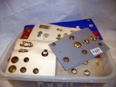 A mixed lot of military badges and buttons