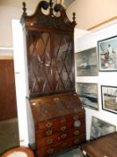 A Victorian tall bureau bookcase with carved flap