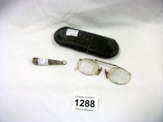 2 pairs of spectacles and a silver cigarette holder in case