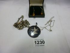 A silver pendant, white metal watch chain,earrings etc