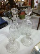 2 cut glass decanters  and a pair of glass candlesticks