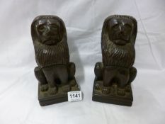 A pair of carved wood lions