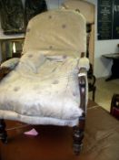 An old mahogany framed armchair in need of reupholstery