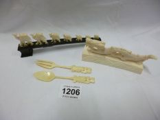 An ivory dragon, ivory set of 7 camels and a bone spoon & fork