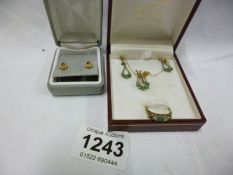A matched set of 9ct gold pendant, ring & earrings and 1 other pair of gold earrings