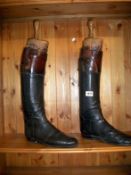 A pair of leather riding boots on trees