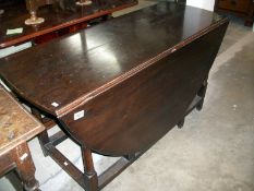 A large oak drop leaf table