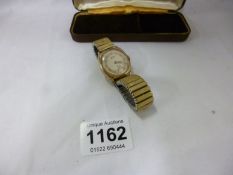 A gold backed Vertex Revue wrist watch
